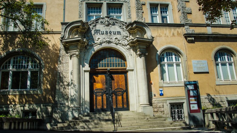 Entrance to the Rollett Museum with decorated archway and staircase.